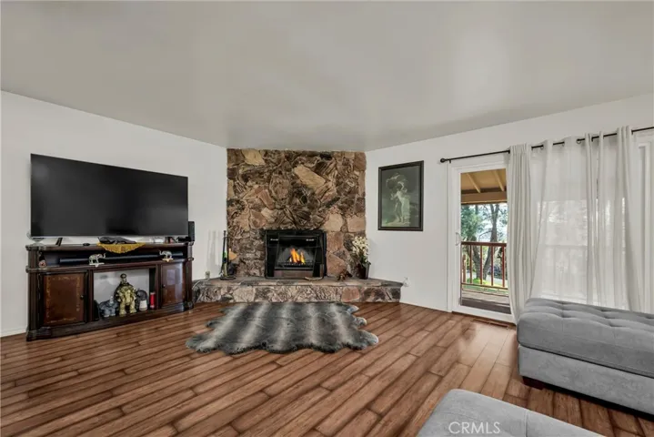Warm and welcoming living area has sliding doors to the covered rear deck.