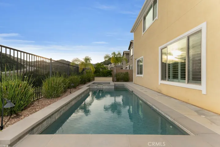 RESORT STYLE BACKYARD
Views
Fully landscaped grounds
Low maintenance evergreen turf lawn
Fruit and citrus trees
Outdoor lighting with automatic sunset activation
Covered outdoor living space
Custom built natural gas barbeque station with refrigerator
Smart app controlled heated in-ground Pebble Tec® lap pool and spa with waterfall and color changing lighting