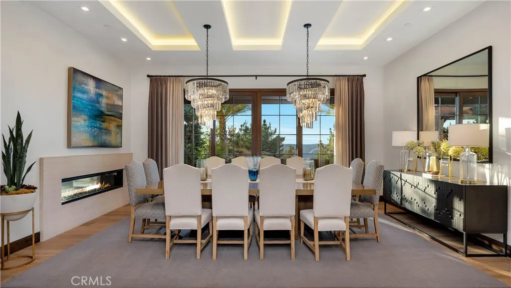  Imagine the dinners you could hold in this magnificent dining room--all while looking at a spectacular view! The recessed lighting on the coffered ceiling and the crystal chandeliers complete the picture. Did you know that every light fixture in the house was placed to exactly enhance the view beyond the fixture itself.
