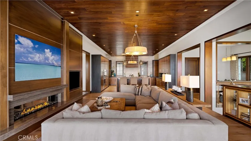 Artfully placed, you get a glimpse of custom lighting, leading to the kitchen.