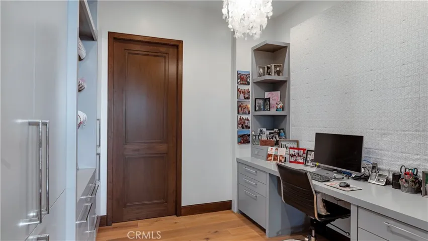 Adjacent to the breakfast area is a home management/craft room. Behind that door, is the biggest pantry you've ever seen.