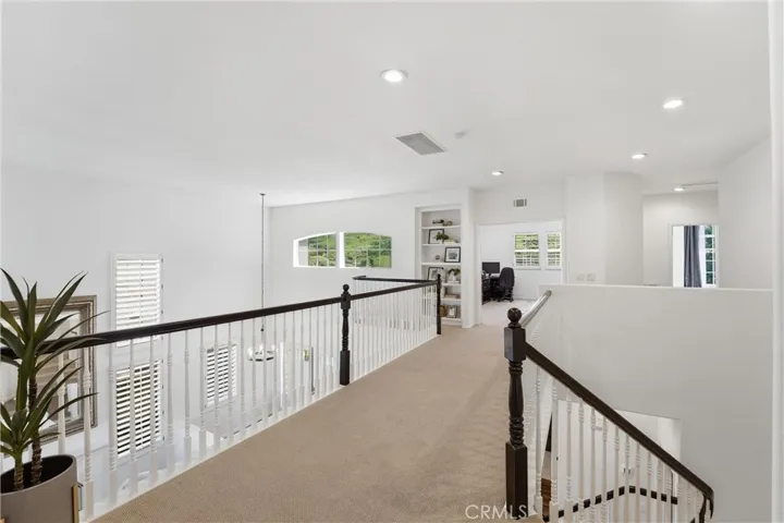 Spacious Hallway with Primary Bedroom on the Opposite end of Secondary Bedrooms