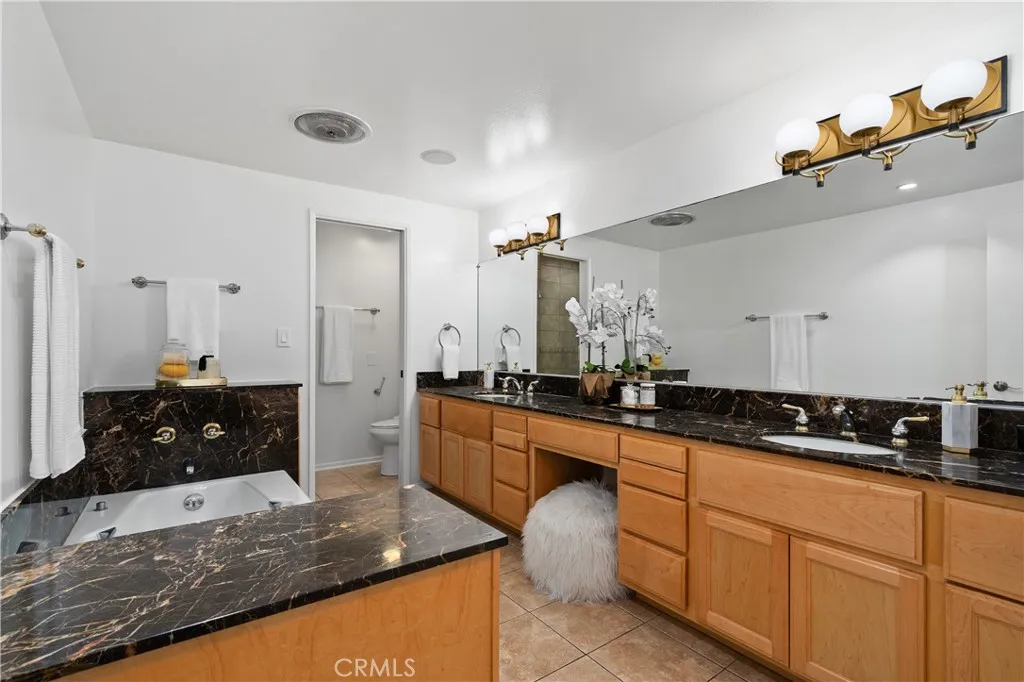The spa inspired bath features an oversized jetted soaking tub, dual sinks with a seated vanity, separate shower area, and private water closet.  Larger bathroom than other floor-plans.