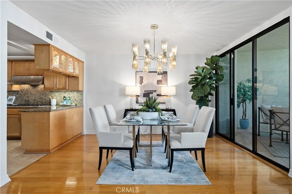 Formal dining room adjacent to the kitchen with direct access to the front balcony, allowing indoor dining to flow naturally to additional outdoor seating for entertaining.