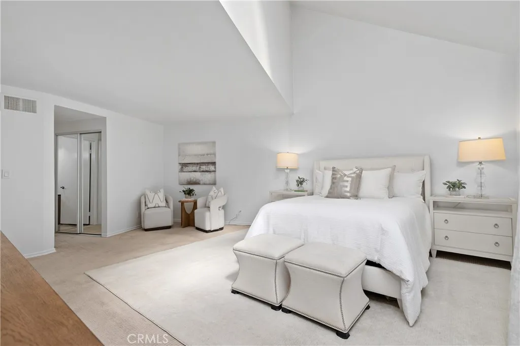 The primary suite is generous in scale with double-door entry, offering high ceilings, a walk in closet, an additional closet, and direct balcony access.
