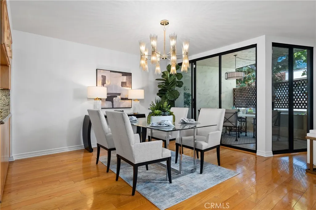 Formal dining room adjacent to the kitchen with direct access to the front balcony, allowing indoor dining to flow naturally to additional outdoor seating for entertaining.