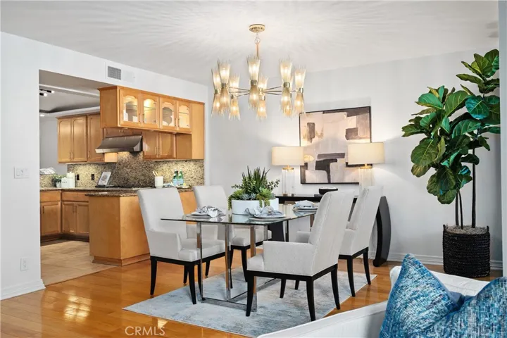 Formal dining room adjacent to the kitchen, allowing a natural flow from preparation to presentation, with direct access to the front balcony for additional outdoor seating.