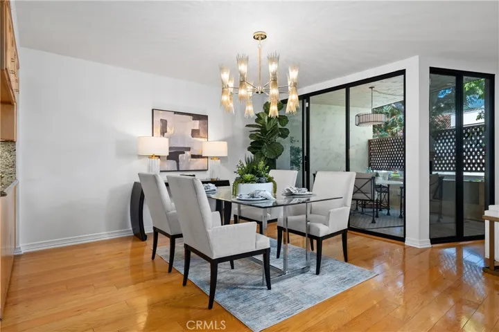 Formal dining room adjacent to the kitchen with direct access to the front balcony, allowing indoor dining to flow naturally to additional outdoor seating for entertaining.