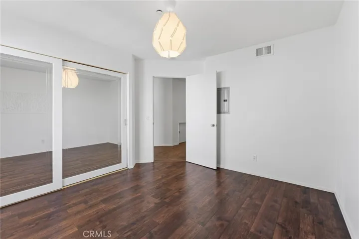Mirrored closet in second bedroom