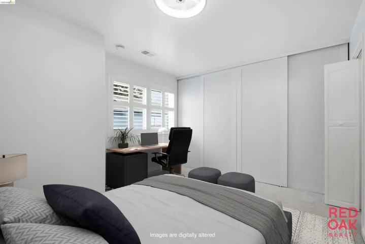 Bedroom with an office area, a closet, and a decorative wall