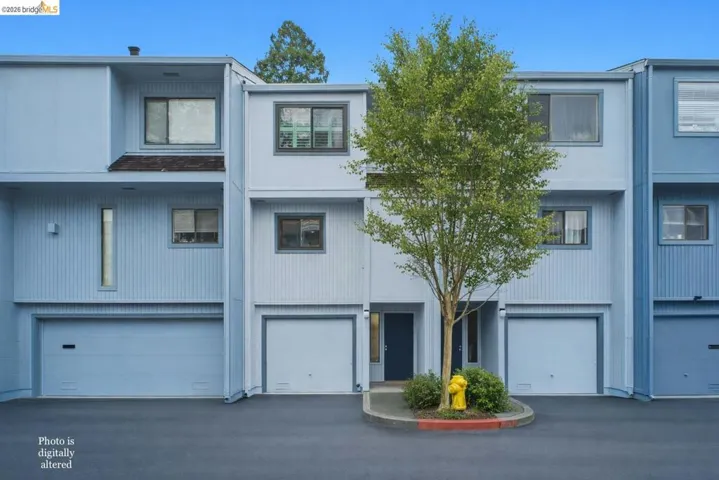 View of front of home with an attached garage and driveway