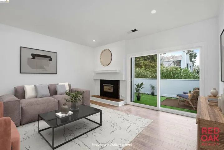Living room with recessed lighting, a tile fireplace, and light wood finished floors