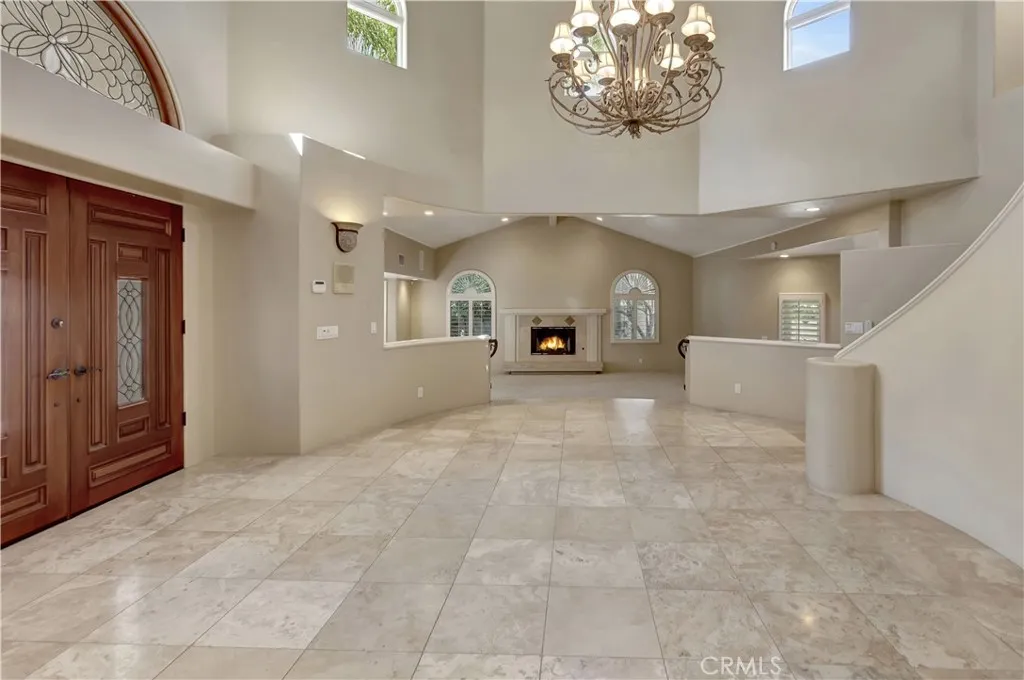 Grand entrance; Living Room (rear of photo) has AI-gen'd flames