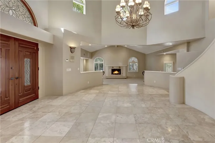 Grand entrance; Living Room (rear of photo) has AI-gen'd flames