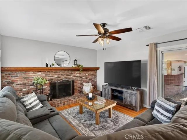 Family Room has an expansive fireplace, ceiling fan, and a view of the backyard.  Hardwood/Tile flooring throughout the home.  No carpet.