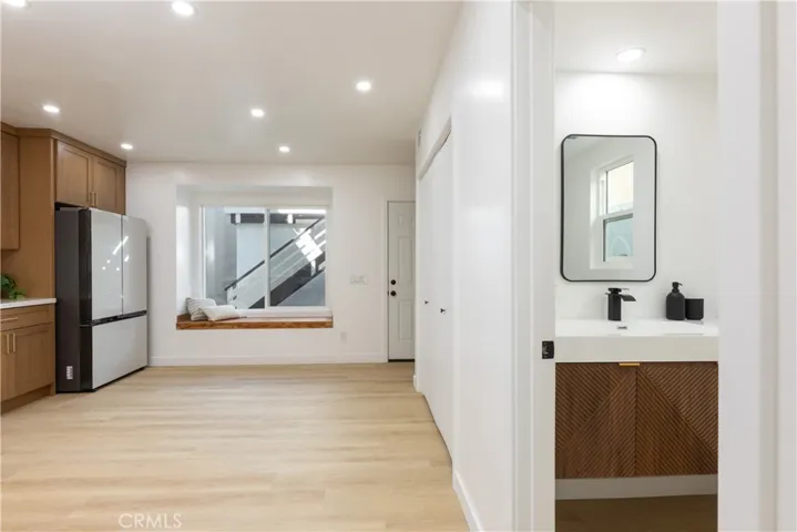 Entering kitchen with powder room to right