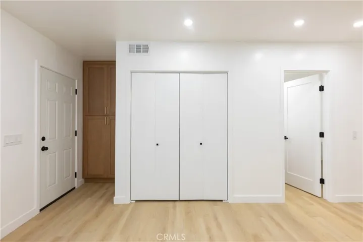 Bathroom, laundry closet and entrance to back patio