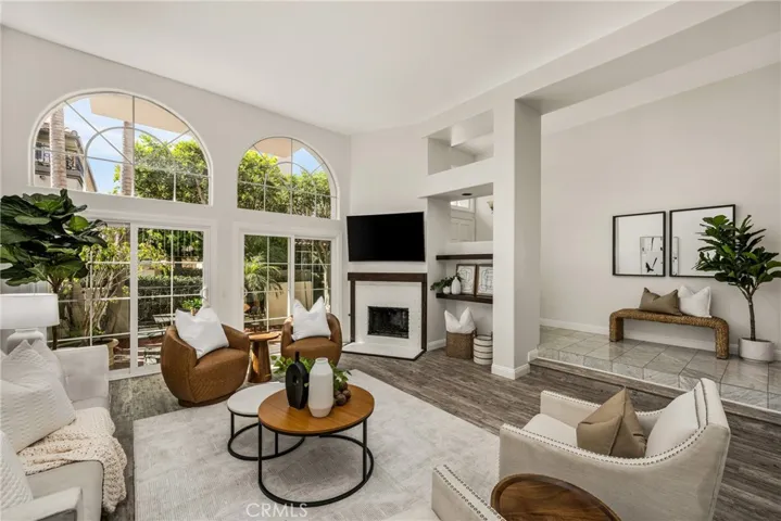 Light filled living room with expansive windows overlooking the patio