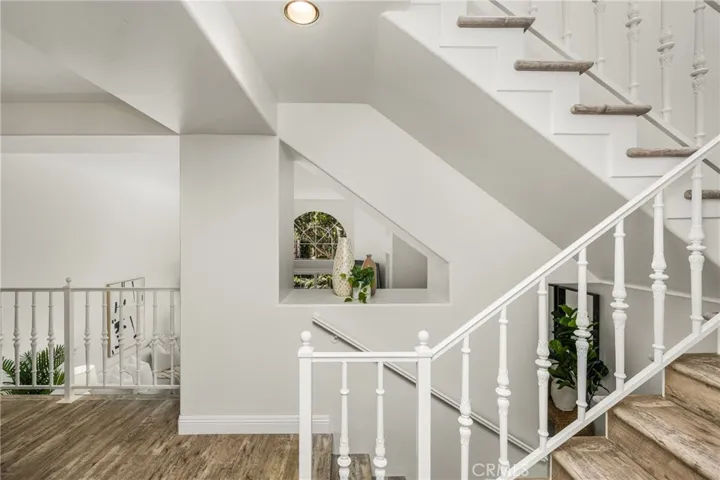 Elegant staircase leads to the upper-level bedroom retreats