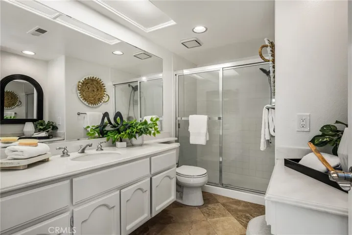Second bedroom en-suite bathroom with walk-in shower and seated vanity