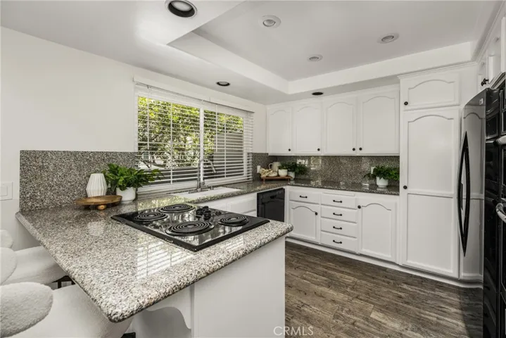 Sun filled kitchen with a window overlooking the terrace