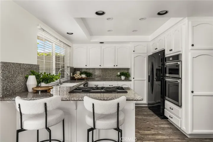 Kitchen featuring a counter with room for barstool seating