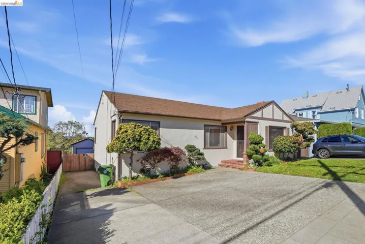 English style home featuring stucco siding and roof with shingles