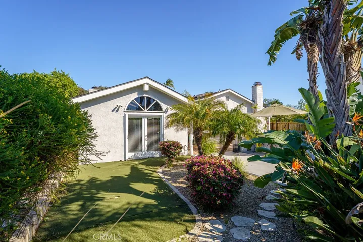 Peter rabbit style backyard (to hide Easter eggs) with a fun putting green. Another set of French doors off the great room!