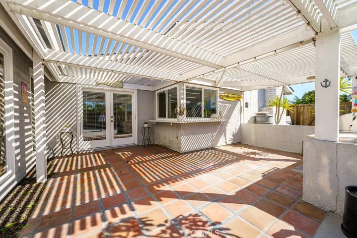 Wonderful patio for filtered sunlight and great California style tiles. French doors off the dining room area.