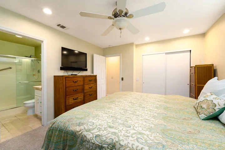 Primary bedroom with recessed lights and ceiling fan. Brand New Carpet in all bedrooms!