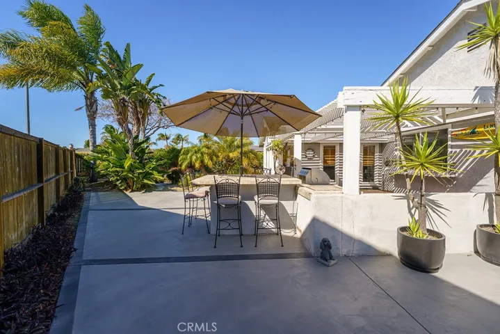 A large patio to entertain with a seating bar for 8