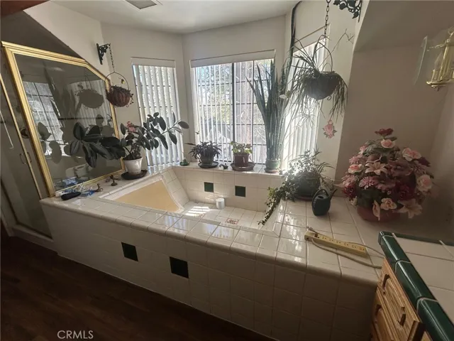 The large jacuzzi style tub adjoin the walk in shower.  Thankfully, the blinds do work...