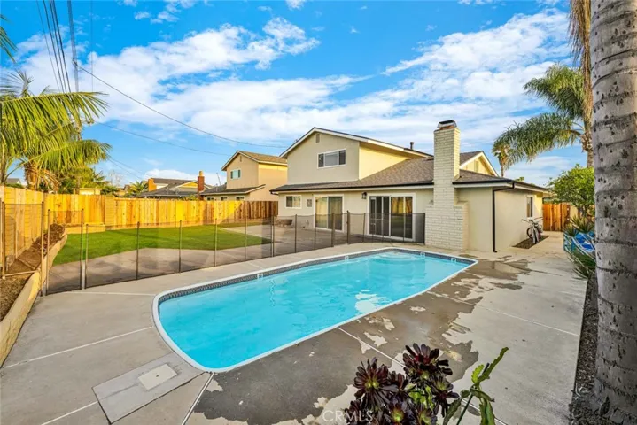 Resort-style backyard featuring sparkling pool and large entertaining area.