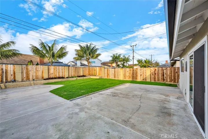 Spacious backyard with open patio and lawn area ideal for entertaining and outdoor living.