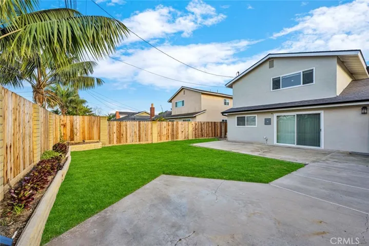 Large private backyard with expansive patio and lawn area offering space for outdoor entertaining or future ADU potential.