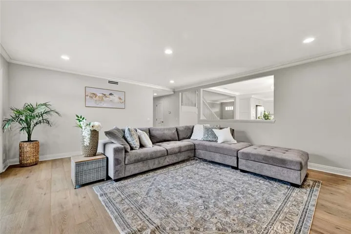 Comfortable living room with engineered wood flooring and open layout.