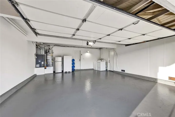 Spacious two-car garage with finished flooring and ample storage space.
