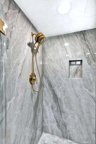 Custom slab finished walk-in shower with premium finishes and modern fixtures.