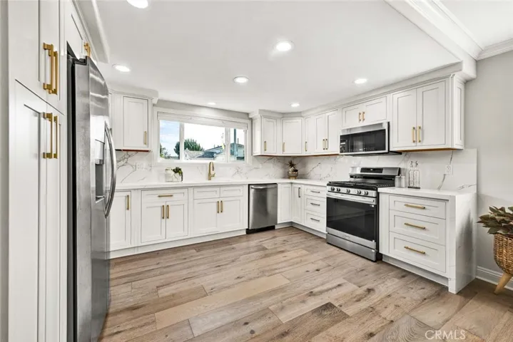 Designer kitchen with quartz countertops, stainless steel appliances, and abundant cabinetry.