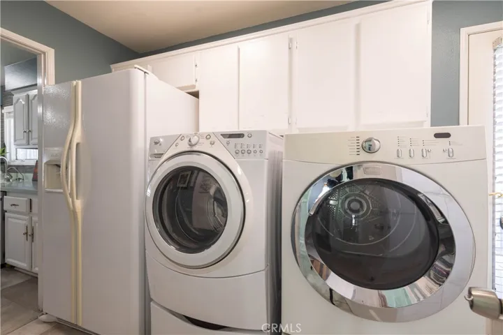 mud/laundry room off kitchen with access to outside side deck