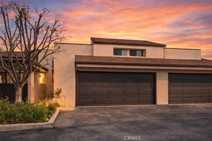 Front of home, two car garage and two parking places in front, digitally altered photo