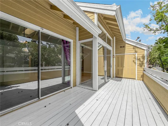 Spansive balcony overlooks the lush landscape and creek below