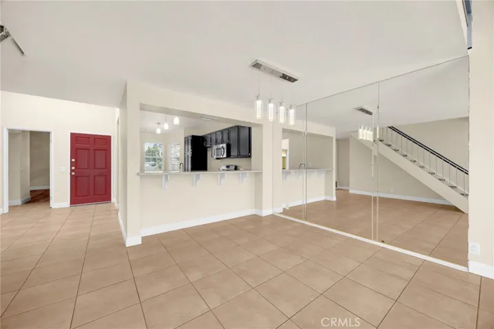 VIRTUALLY STAGED Dining table area between kitchen & living room