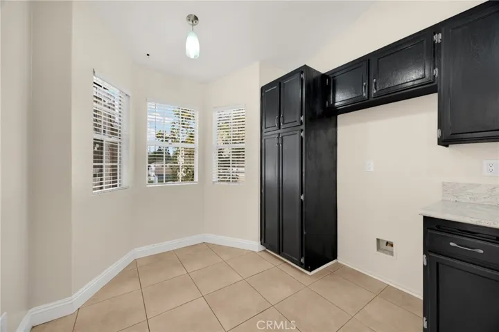 Modern kitchen is spacious and has room for a small bistro or mobile island.