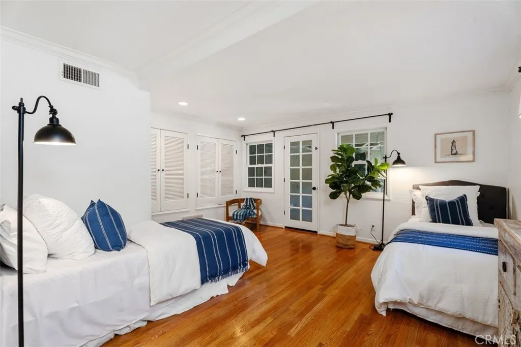 Guest Bedroom #4 is located on the first floor and has a door leading outside to the garden, along with an ensuite bathroom.