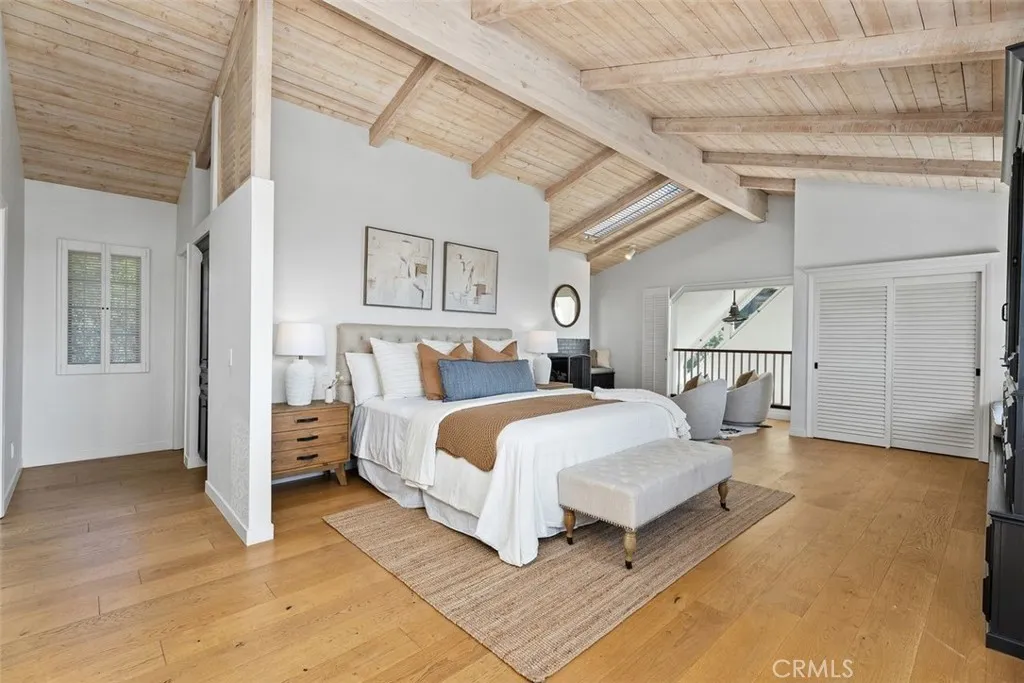 The spacious primary bedroom suite located upstairs. Vaulted ceilings and ocean views make this quite it's own special area.