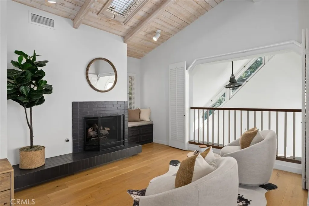 The primary bedroom retreat area is a perfect place to cozy up with a book next to the fireplace.
