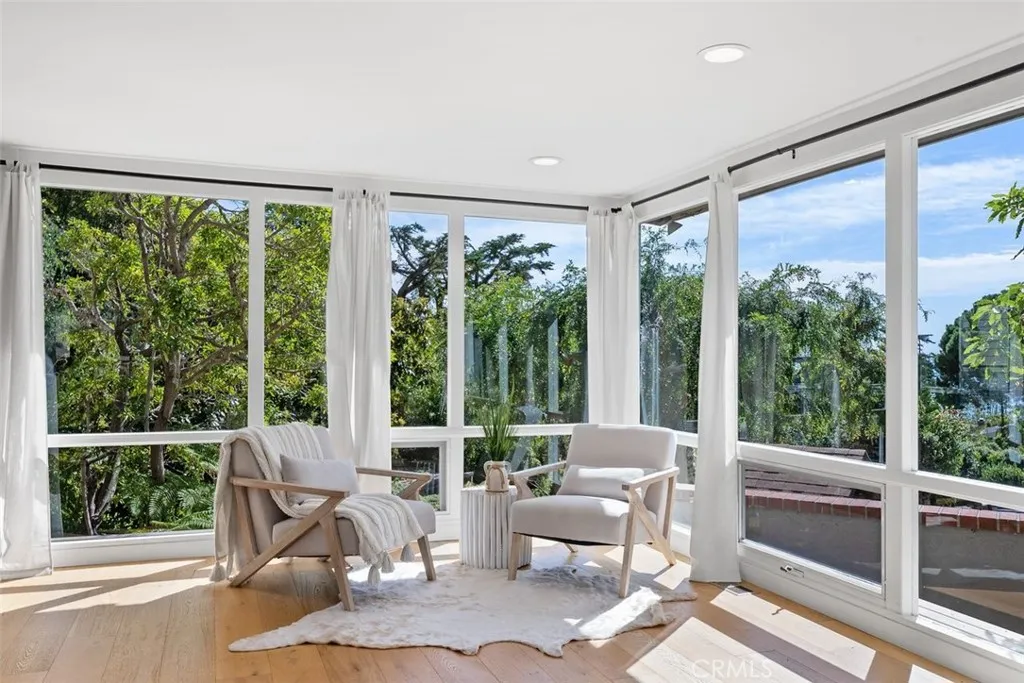 A serene corner in the bonus room with wonderful natural light and views of the garden.