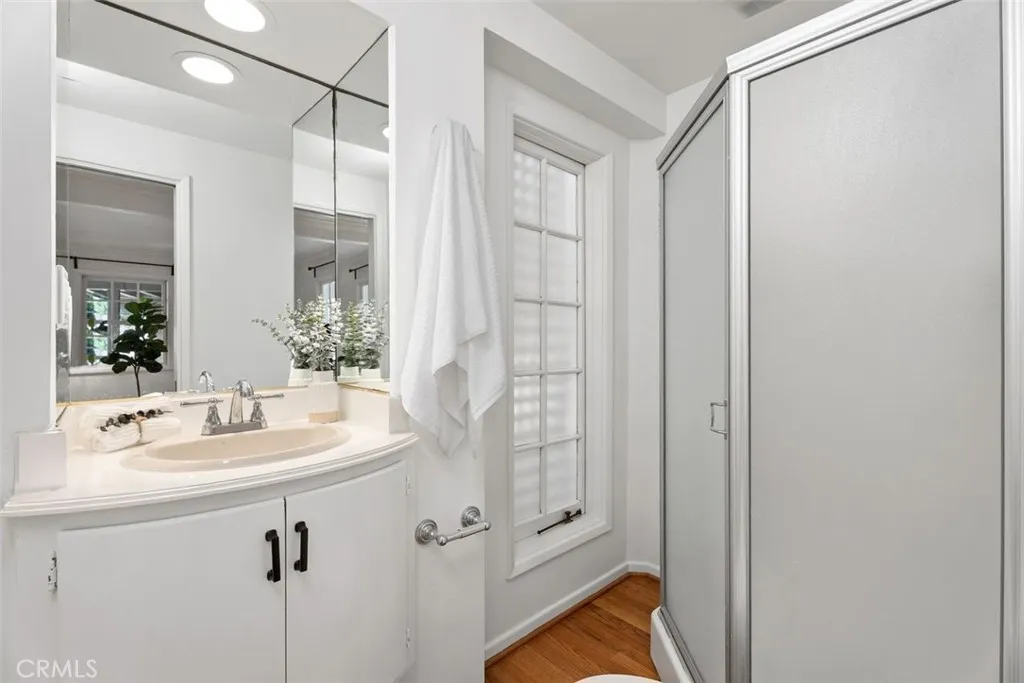 The ensuite bathroom to guest bedroom #4 is complete with a shower.