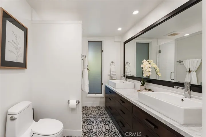 The guest bathroom on the first floor has a dual vanity and shower.